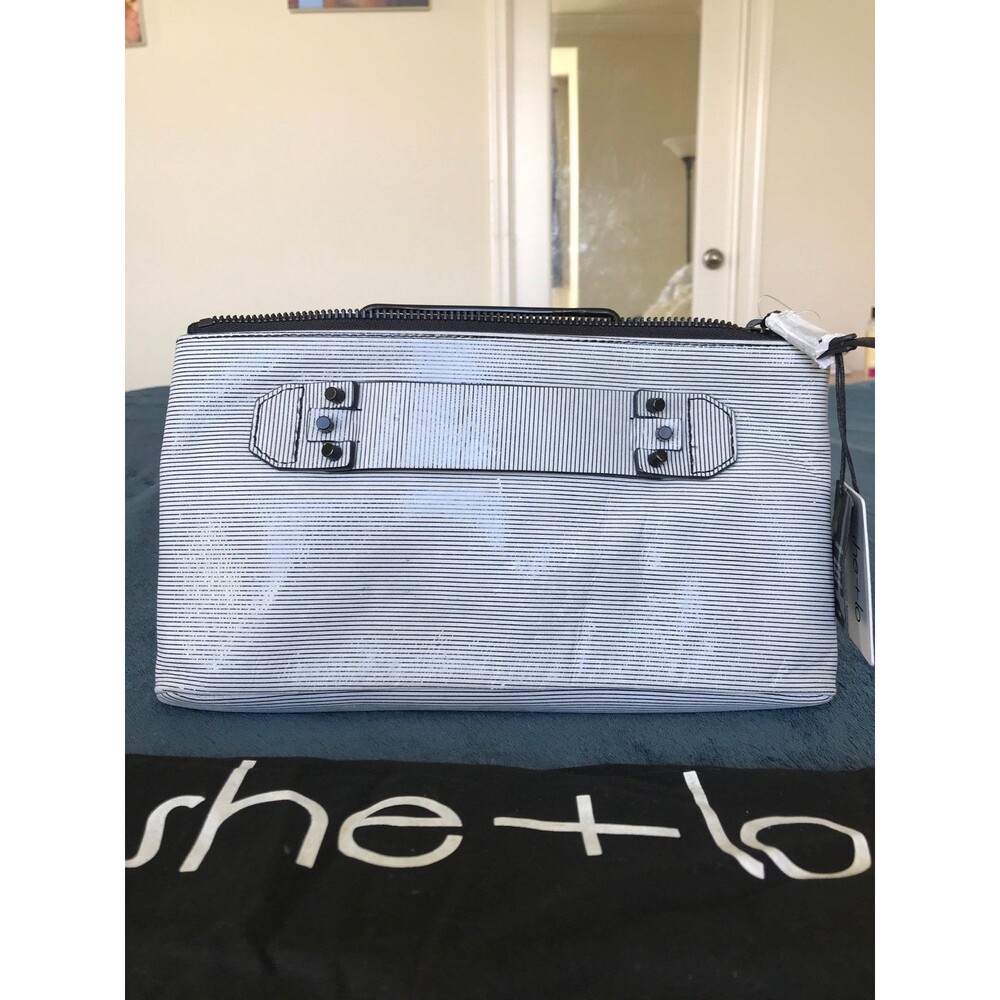 She + LO striped leather next chapter clutch in gray and black with studs